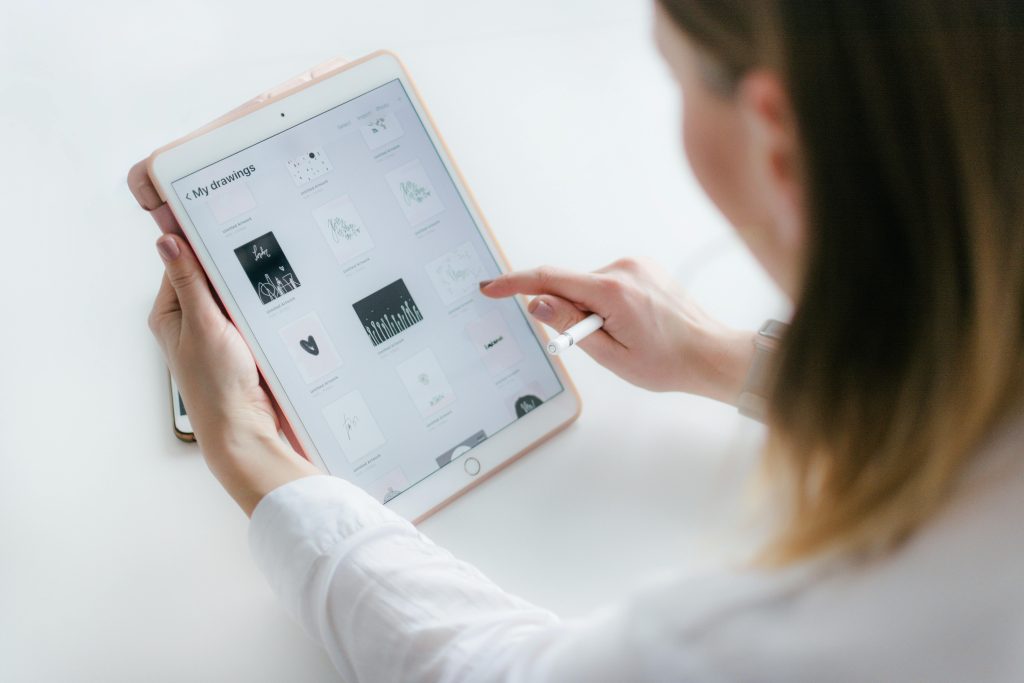 pexels-photo-2265482-2265482 A woman interacts with a tablet to create digital art. Ideal for technology and creativity concepts.